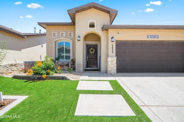 3452 David Palacio Dr, El Paso, TX 79938 - mediterranean / spanish-style home featuring an attached garage, driveway, a front yard, stucco siding, and stone siding