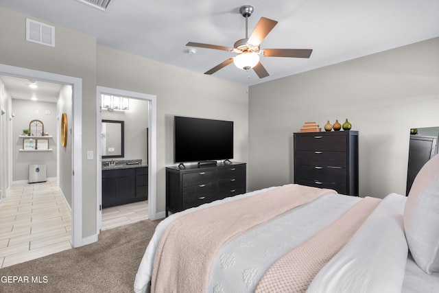 3452 David Palacio Dr, El Paso, TX 79938 - bedroom with light carpet, ensuite bathroom, and a ceiling fan