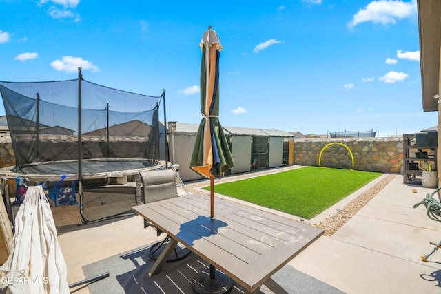 3452 David Palacio Dr, El Paso, TX 79938 - fenced backyard with a trampoline, a patio area, a shed, and outdoor dining space