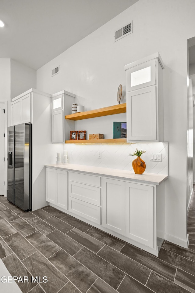 1453 Indigo Sky St, El Paso, TX 79928 - kitchen featuring stainless steel fridge with ice dispenser, light countertops, white cabinets, open shelves, and decorative backsplash