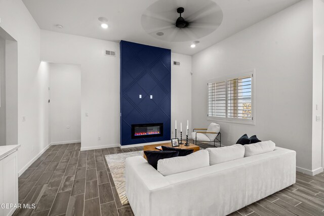1453 Indigo Sky St, El Paso, TX 79928 - living area featuring wood finish floors, a ceiling fan, a large fireplace, baseboards, and recessed lighting