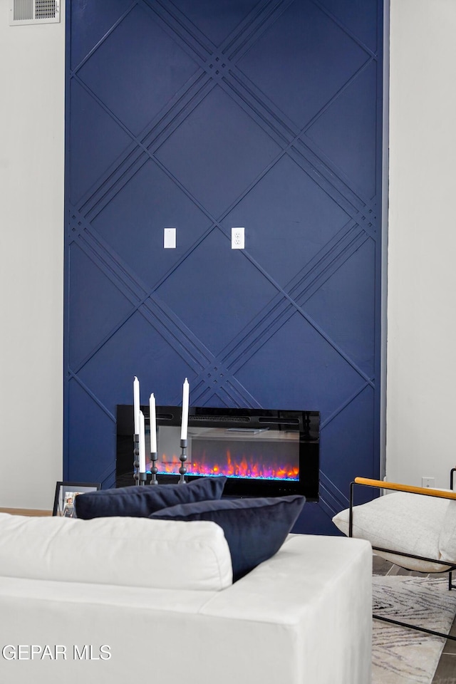 1453 Indigo Sky St, El Paso, TX 79928 - living room with a lit fireplace and a decorative wall
