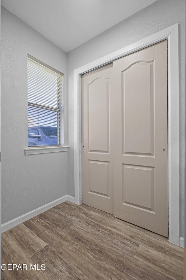 14236 Rattler Point Dr, El Paso, TX 79938 - unfurnished bedroom with a closet, wood finished floors, and baseboards