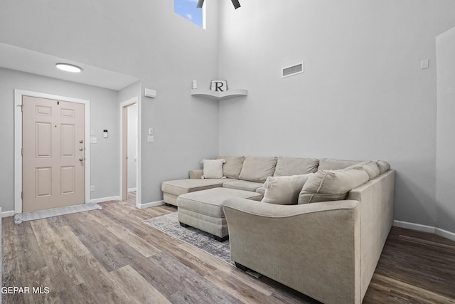 14236 Rattler Point Dr, El Paso, TX 79938 - living area featuring wood finished floors, baseboards, and a high ceiling
