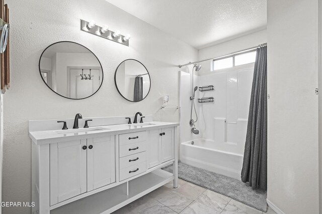 14236 Rattler Point Dr, El Paso, TX 79938 - full bath with shower / bath combo with shower curtain, double vanity, and a textured ceiling