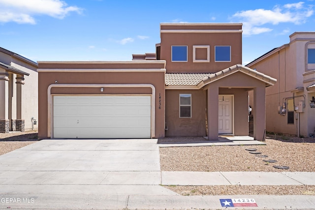 14236 Rattler Point Dr, El Paso, TX 79938 - view of front facade featuring stucco siding, a tile roof, driveway, and an attached garage