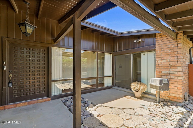 3134 Mesa Verde Ln, El Paso, TX 79904 - property entrance featuring board and batten siding, a patio, and a wall unit AC