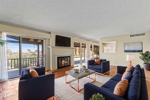 3134 Mesa Verde Ln, El Paso, TX 79904 - living room featuring a chandelier and a glass covered fireplace