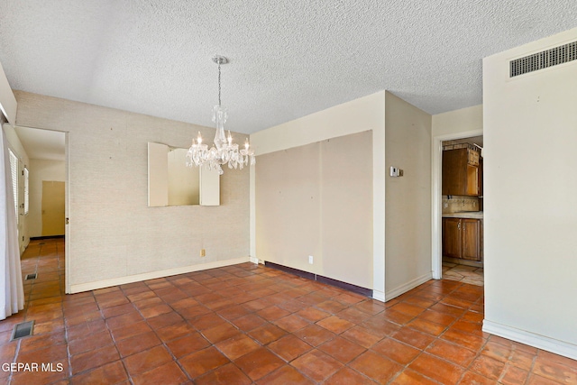 3134 Mesa Verde Ln, El Paso, TX 79904 - spare room with a chandelier, baseboards, tile patterned floors, and a textured ceiling