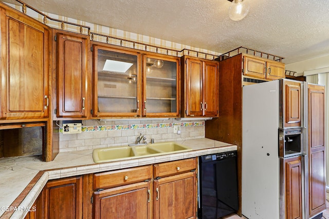 3134 Mesa Verde Ln, El Paso, TX 79904 - kitchen featuring dishwasher, fridge with ice dispenser, a sink, a textured ceiling, and light countertops
