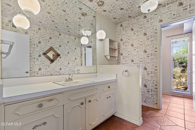 3134 Mesa Verde Ln, El Paso, TX 79904 - bathroom with vanity, wallpapered walls, tile patterned flooring, baseboards, and vaulted ceiling