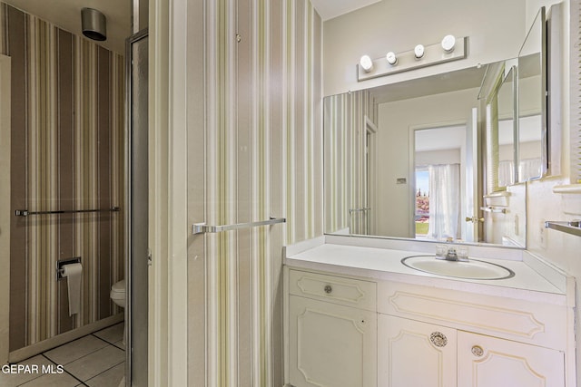 3134 Mesa Verde Ln, El Paso, TX 79904 - bathroom with vanity, toilet, wallpapered walls, and tile patterned floors