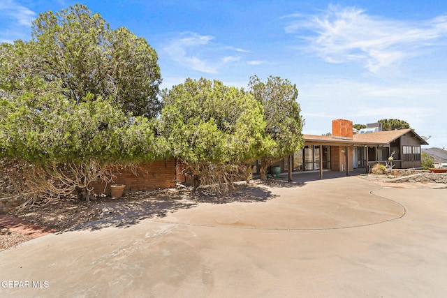 3134 Mesa Verde Ln, El Paso, TX 79904 - view of front of house featuring a patio area and a chimney
