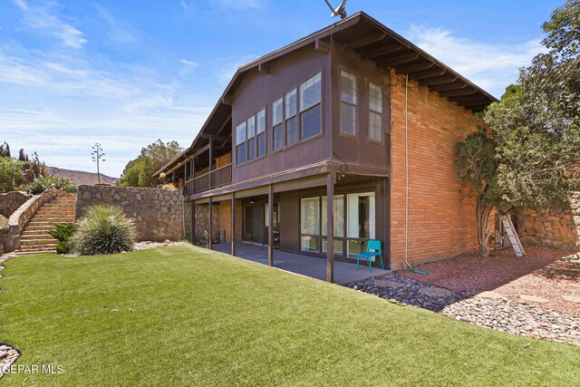 3134 Mesa Verde Ln, El Paso, TX 79904 - rear view of house with a lawn, a patio, stairway, and brick siding