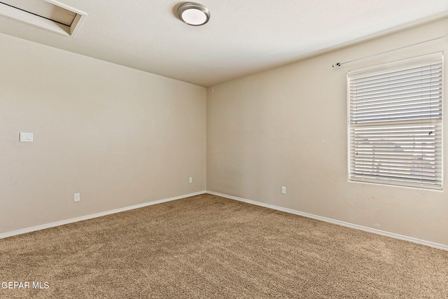 14840 Tim Hardaway, El Paso, TX 79938 - empty room with carpet floors, baseboards, and attic access