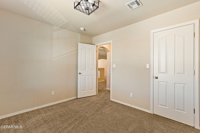 14840 Tim Hardaway, El Paso, TX 79938 - unfurnished bedroom with arched walkways, carpet, and baseboards