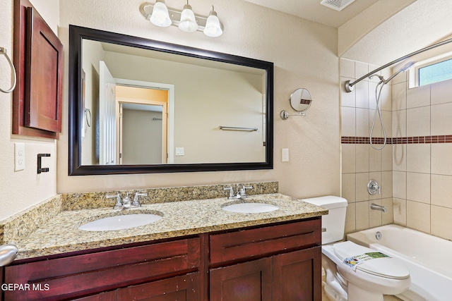 14840 Tim Hardaway, El Paso, TX 79938 - bathroom with toilet, double vanity, tub / shower combination, and a textured wall