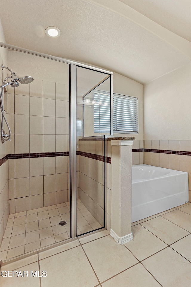 14840 Tim Hardaway, El Paso, TX 79938 - bathroom featuring a shower stall, a bath, tile patterned flooring, and recessed lighting