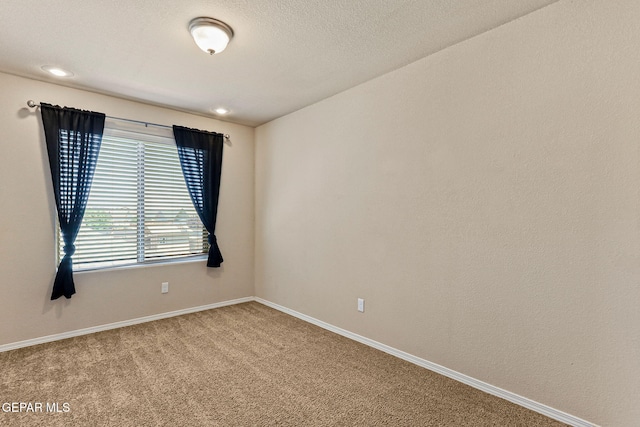 14840 Tim Hardaway, El Paso, TX 79938 - spare room featuring carpet and baseboards