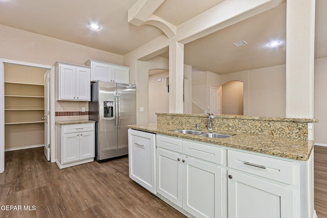14840 Tim Hardaway, El Paso, TX 79938 - kitchen featuring stainless steel refrigerator with ice dispenser, a sink, arched walkways, and dark wood-type flooring