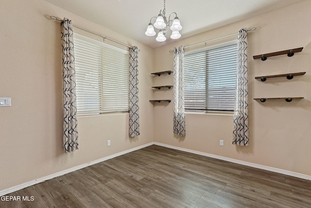 14840 Tim Hardaway, El Paso, TX 79938 - spare room with a chandelier, wood finished floors, and baseboards