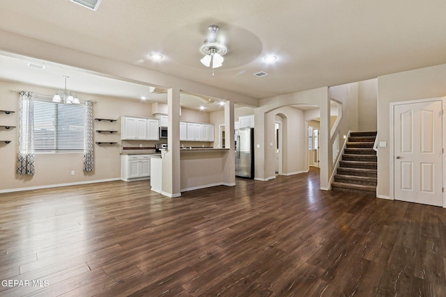 14840 Tim Hardaway, El Paso, TX 79938 - unfurnished living room with dark wood finished floors, a chandelier, arched walkways, ceiling fan, and recessed lighting