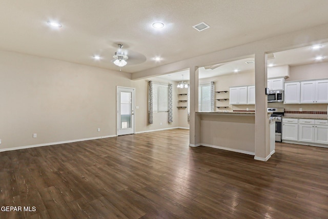 14840 Tim Hardaway, El Paso, TX 79938 - unfurnished living room with a ceiling fan, dark wood-style flooring, baseboards, recessed lighting, and a chandelier