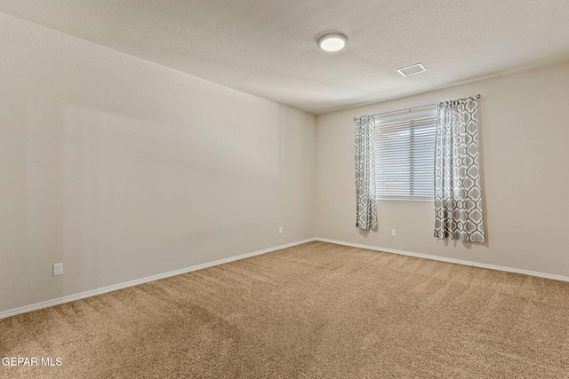 14840 Tim Hardaway, El Paso, TX 79938 - unfurnished room featuring carpet, baseboards, and a textured ceiling