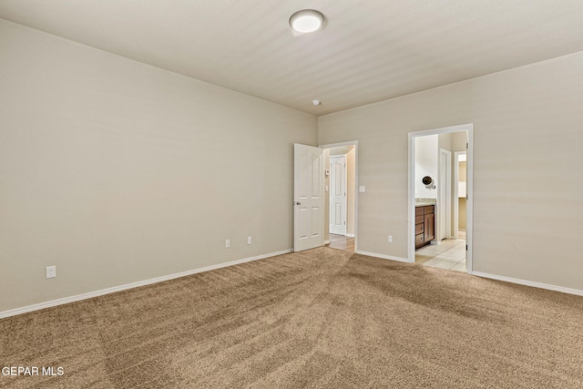 14840 Tim Hardaway, El Paso, TX 79938 - unfurnished bedroom featuring light carpet, baseboards, and ensuite bathroom