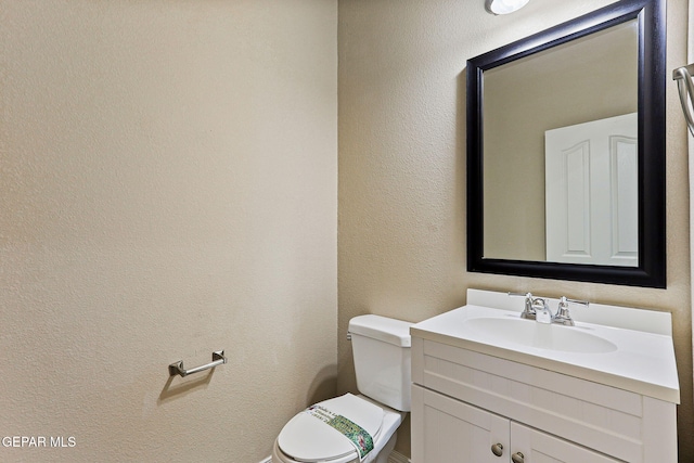14840 Tim Hardaway, El Paso, TX 79938 - bathroom with toilet, vanity, and a textured wall