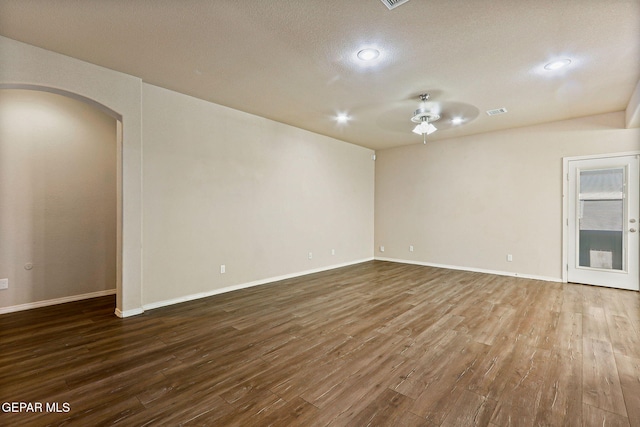 14840 Tim Hardaway, El Paso, TX 79938 - empty room featuring a ceiling fan, dark wood-type flooring, arched walkways, baseboards, and recessed lighting