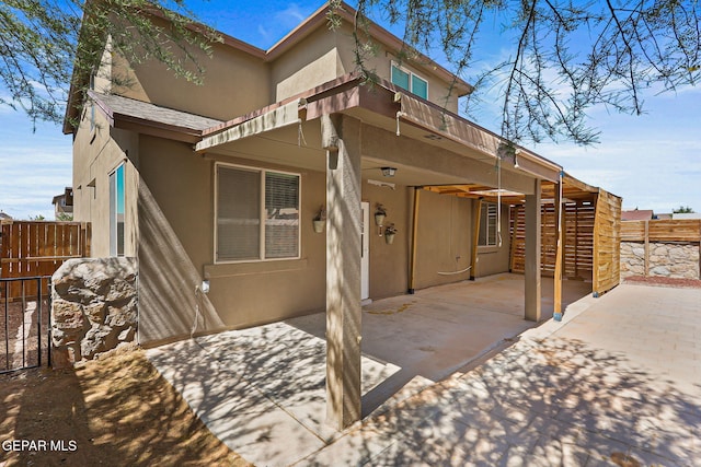 14840 Tim Hardaway, El Paso, TX 79938 - back of property featuring stucco siding and a patio