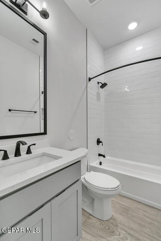 248 Emerald Storm Pl, El Paso, TX 79928 - full bathroom featuring vanity,  shower combination, toilet, and wood finished floors