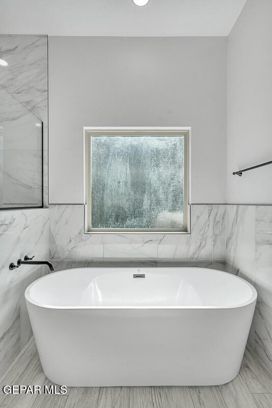 248 Emerald Storm Pl, El Paso, TX 79928 - full bathroom with tile walls and a soaking tub