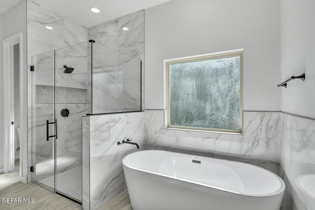 248 Emerald Storm Pl, El Paso, TX 79928 - bathroom with a marble finish shower, tile walls, a freestanding tub, and recessed lighting