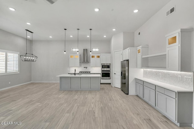 248 Emerald Storm Pl, El Paso, TX 79928 - kitchen with wall chimney exhaust hood, stainless steel appliances, open shelves, a sink, and tasteful backsplash