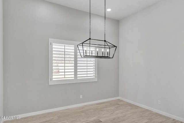 248 Emerald Storm Pl, El Paso, TX 79928 - unfurnished room with wood finished floors, a chandelier, and baseboards