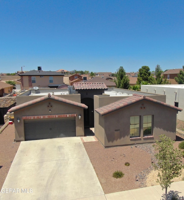 12217 Chapel Hill Rd, El Paso, TX 79928 - view of front of home featuring stucco siding, a tile roof, driveway, an attached garage, and a residential view