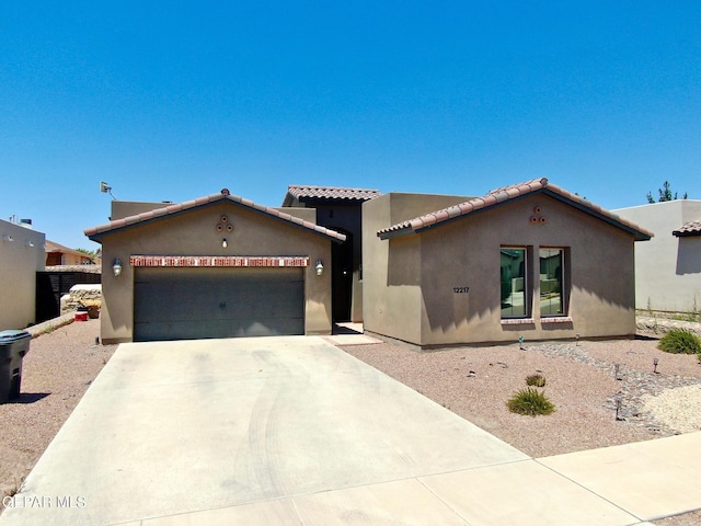 12217 Chapel Hill Rd, El Paso, TX 79928 - view of front of house with stucco siding, an attached garage, concrete driveway, and a tiled roof