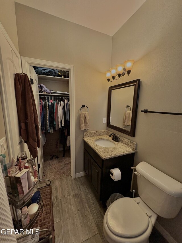 12217 Chapel Hill Rd, El Paso, TX 79928 - bathroom featuring vanity, wood finished floors, and a spacious closet