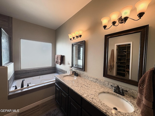 12217 Chapel Hill Rd, El Paso, TX 79928 - bathroom featuring double vanity, a bath, wood finished floors, and plenty of natural light