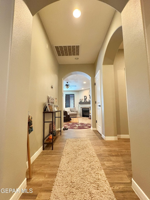12217 Chapel Hill Rd, El Paso, TX 79928 - hall featuring light wood finished floors and arched walkways