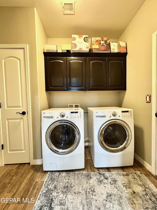 12217 Chapel Hill Rd, El Paso, TX 79928 - laundry area featuring cabinet space, separate washer and dryer, and wood finished floors