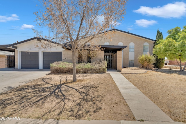 1460 Backus St, El Paso, TX 79925 - single story home with brick siding, a garage, and driveway