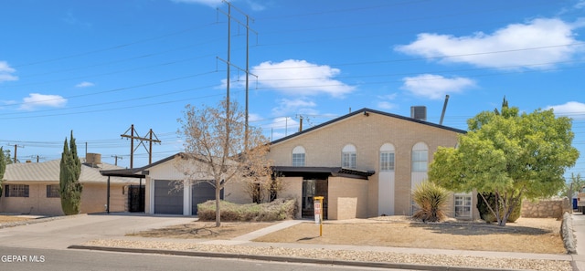 1460 Backus St, El Paso, TX 79925 - view of front of house with brick siding, driveway, and an attached garage