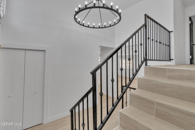 1460 Backus St, El Paso, TX 79925 - staircase featuring a chandelier and wood finished floors