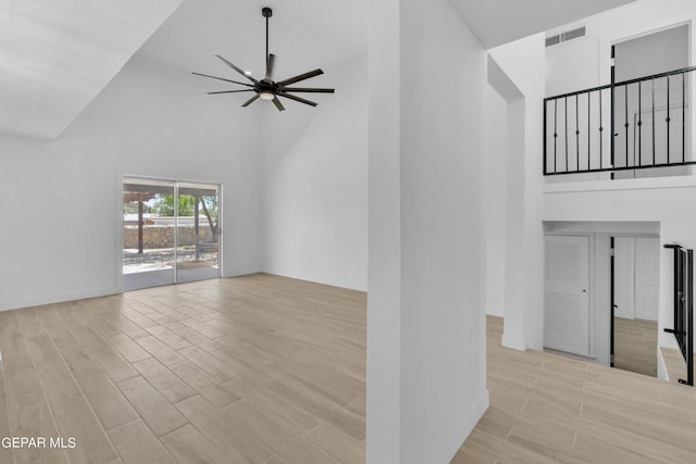 1460 Backus St, El Paso, TX 79925 - unfurnished living room featuring high vaulted ceiling, wood finished floors, ceiling fan, and baseboards