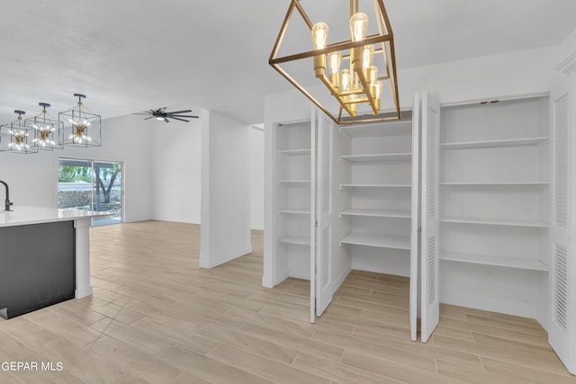 1460 Backus St, El Paso, TX 79925 - spacious closet with a chandelier, light wood-type flooring, a ceiling fan, and a sink