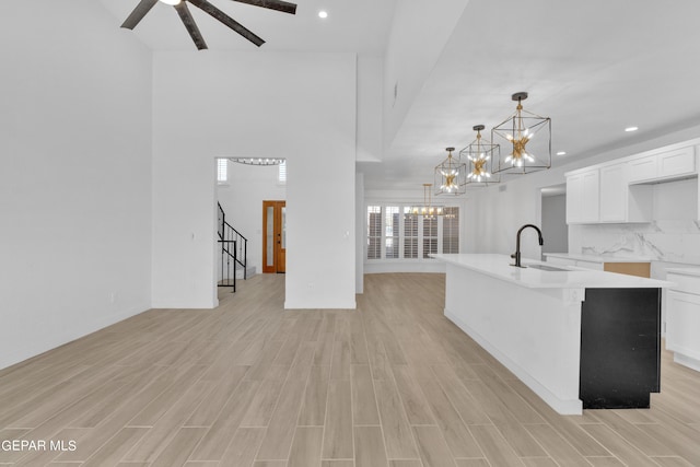 1460 Backus St, El Paso, TX 79925 - living room with a chandelier, light wood-style floors, stairway, recessed lighting, and baseboards