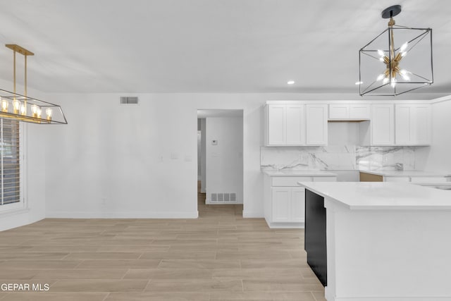 1460 Backus St, El Paso, TX 79925 - kitchen featuring a chandelier, white cabinetry, recessed lighting, baseboards, and tasteful backsplash